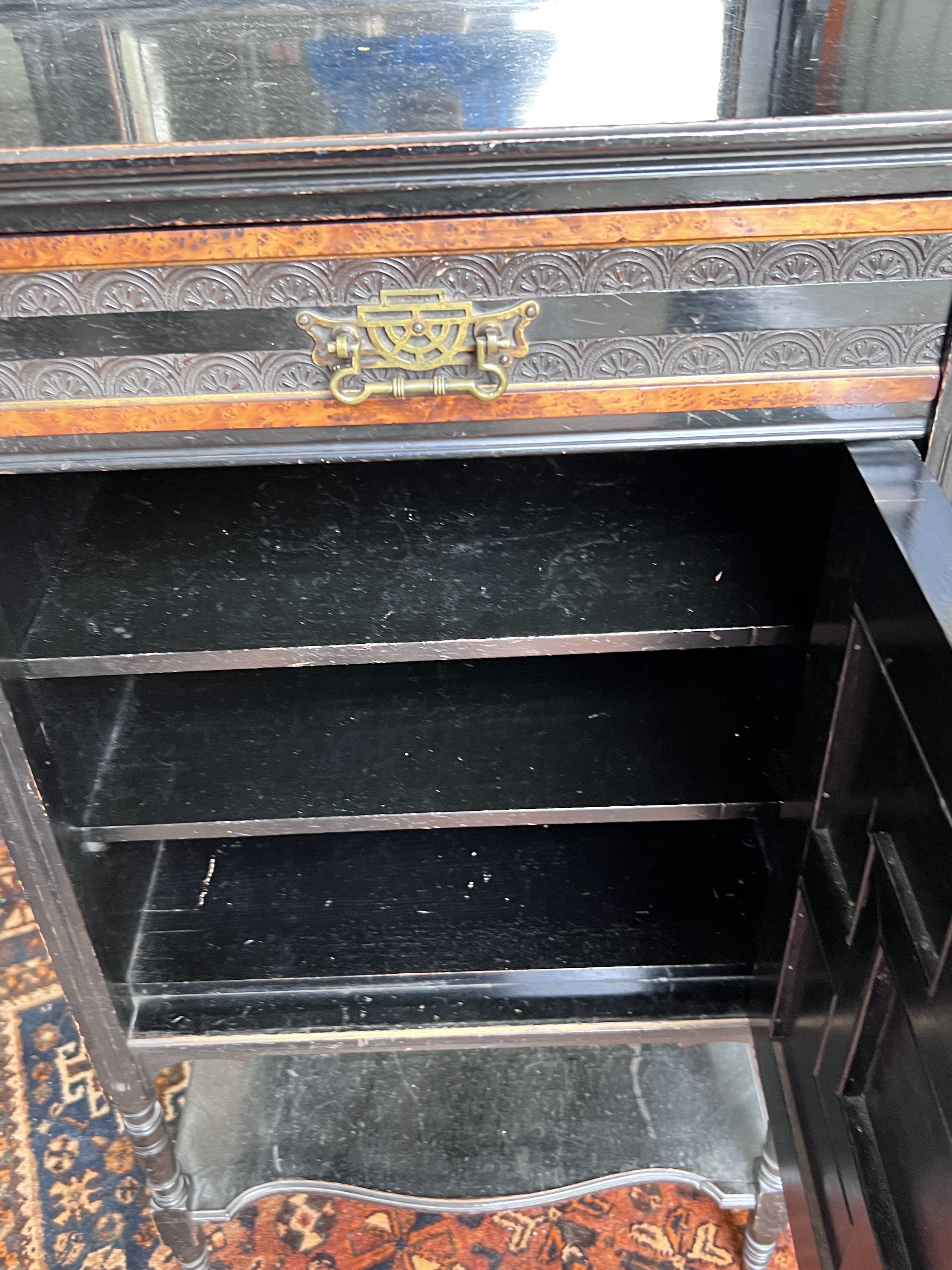 A late Victorian aesthetic movement ebonised amboyna side cabinet, width 55cm, depth 40cm, height 131cm